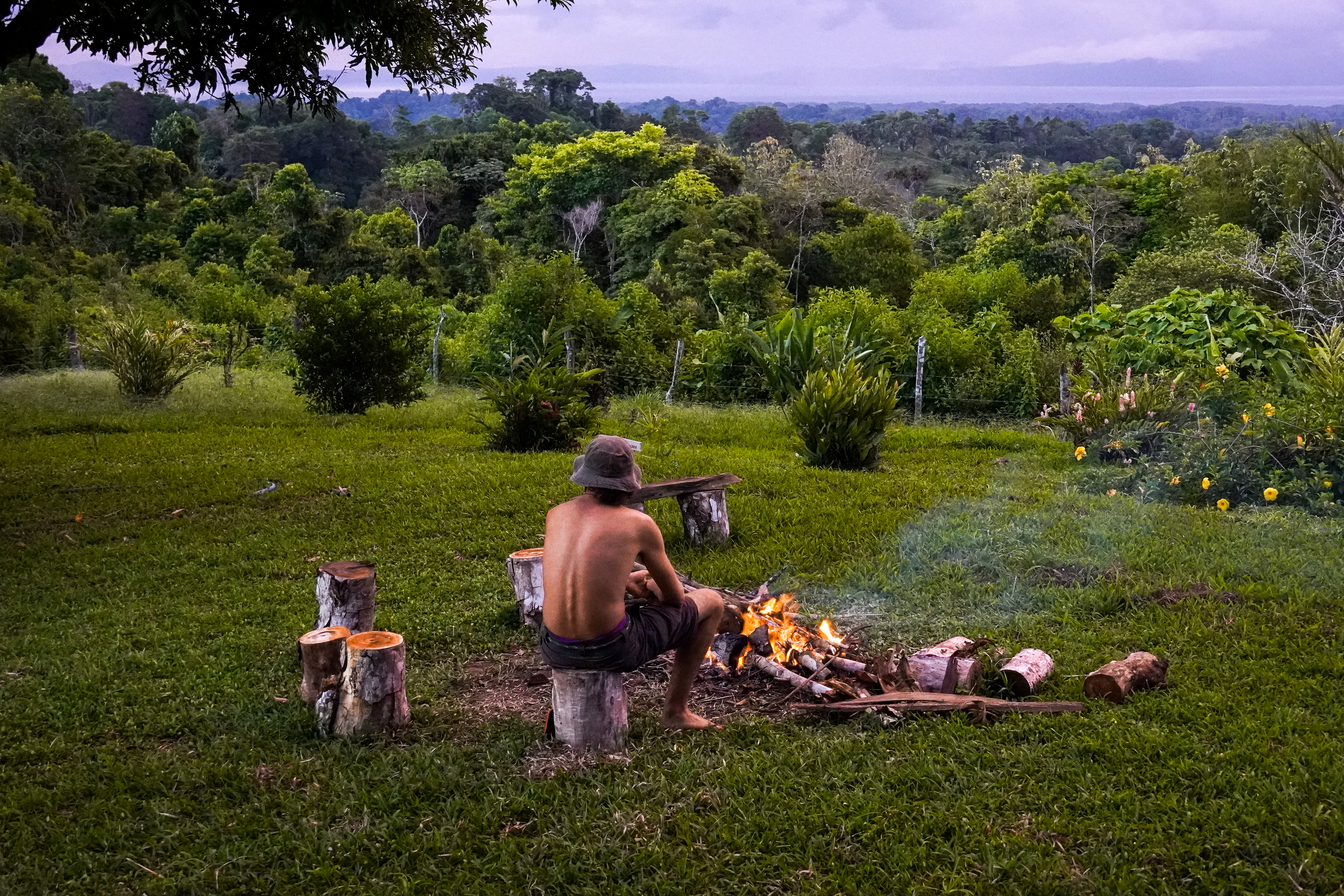 Jackson sitting by the fire at the farm